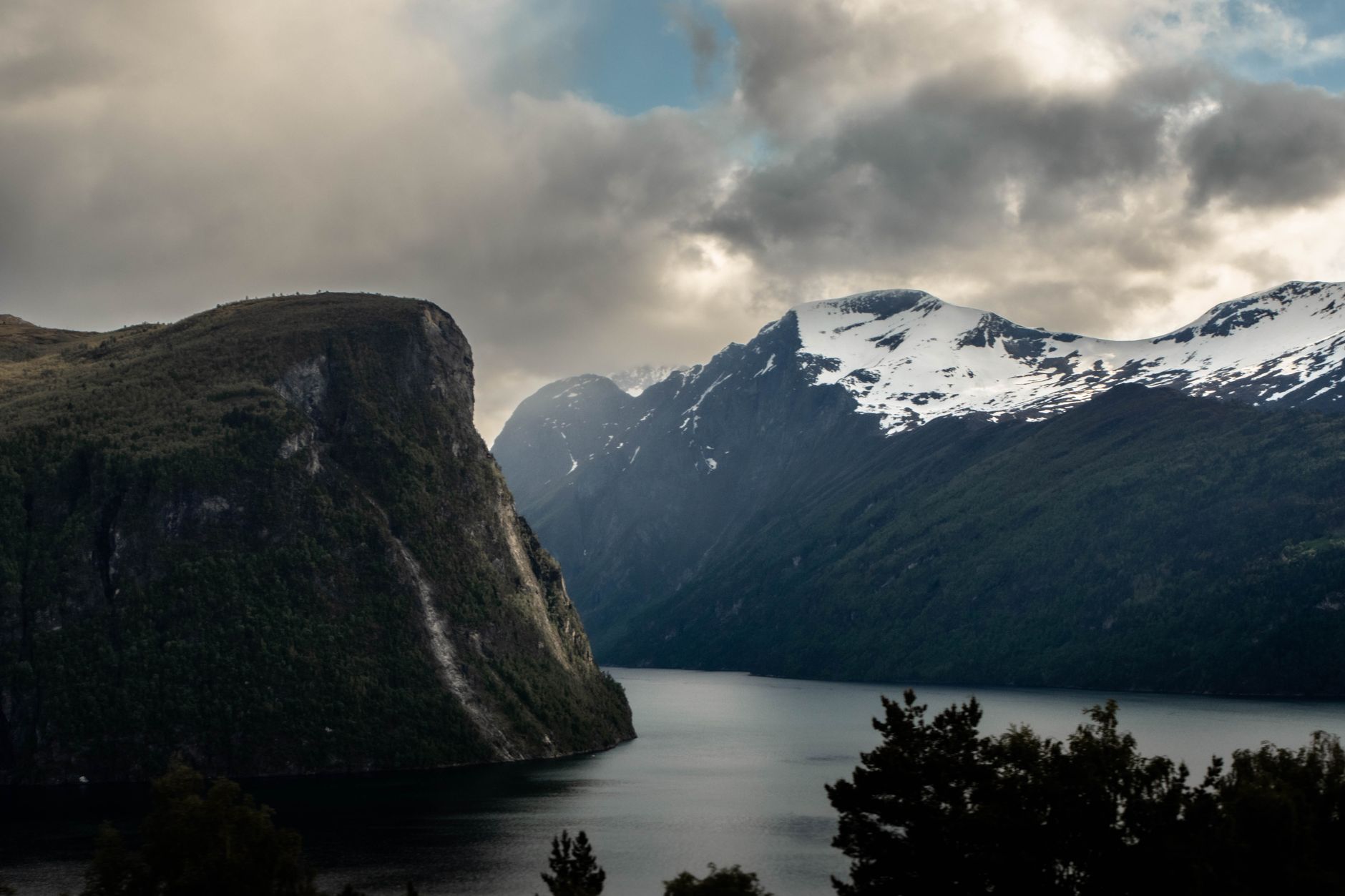 Glacial waters in deep Norwegian fjord during late autumn twilight